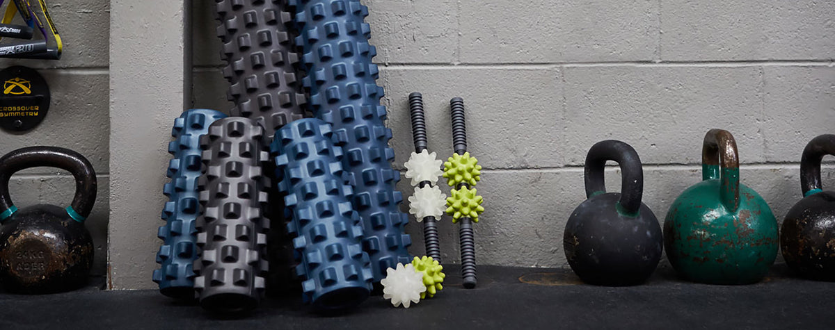 The full range of RumbleRoller and Beastie tools on a gym floor